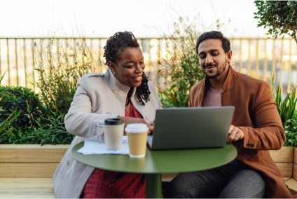 Image of two people looking at laptop