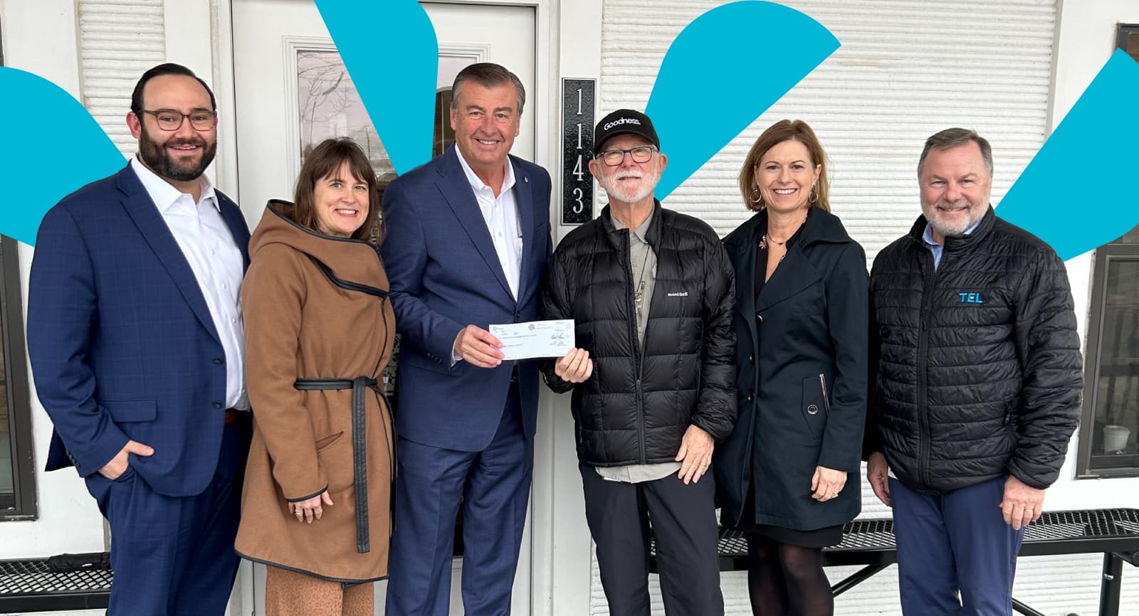 Group of people holding a check