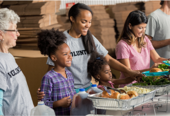 youth and adults giving out food