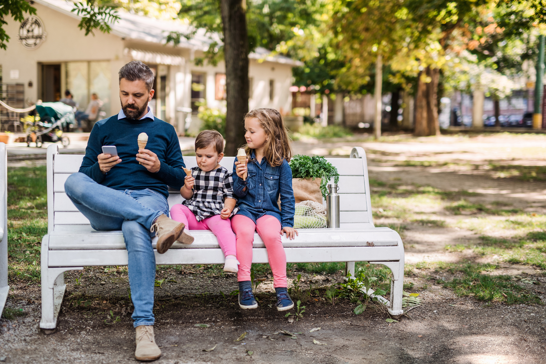 Image of a dad with two kids eating ice cream